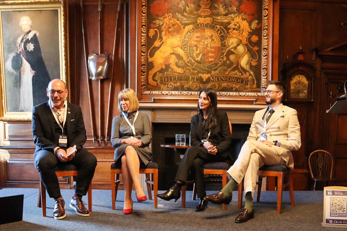 Alper Zan speaking at a hospitality event, 2023